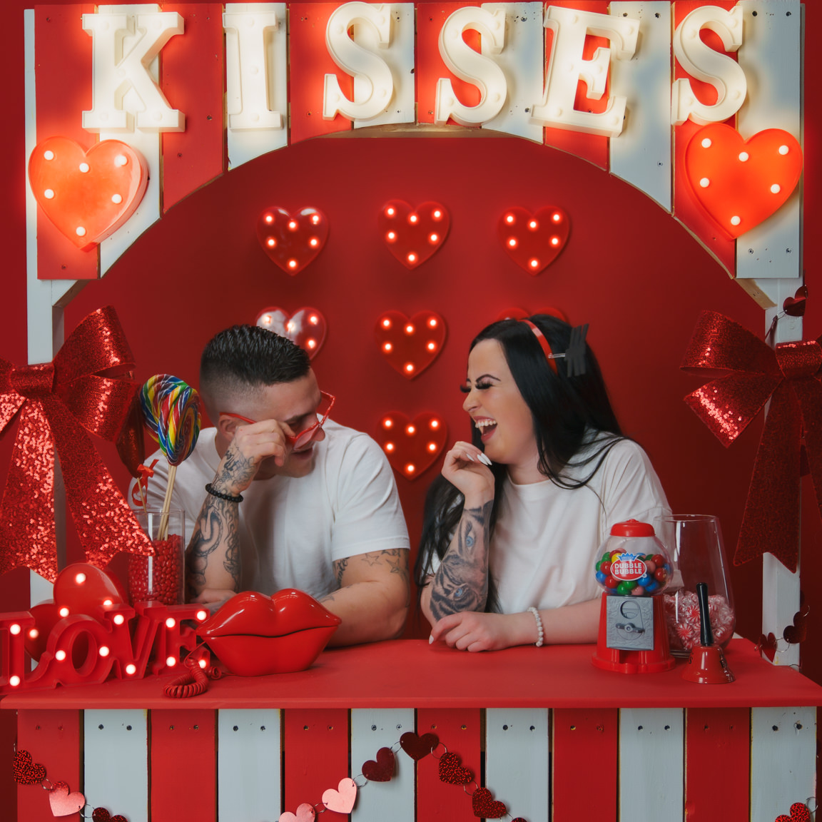 Couple at kissing booth at snap foto club