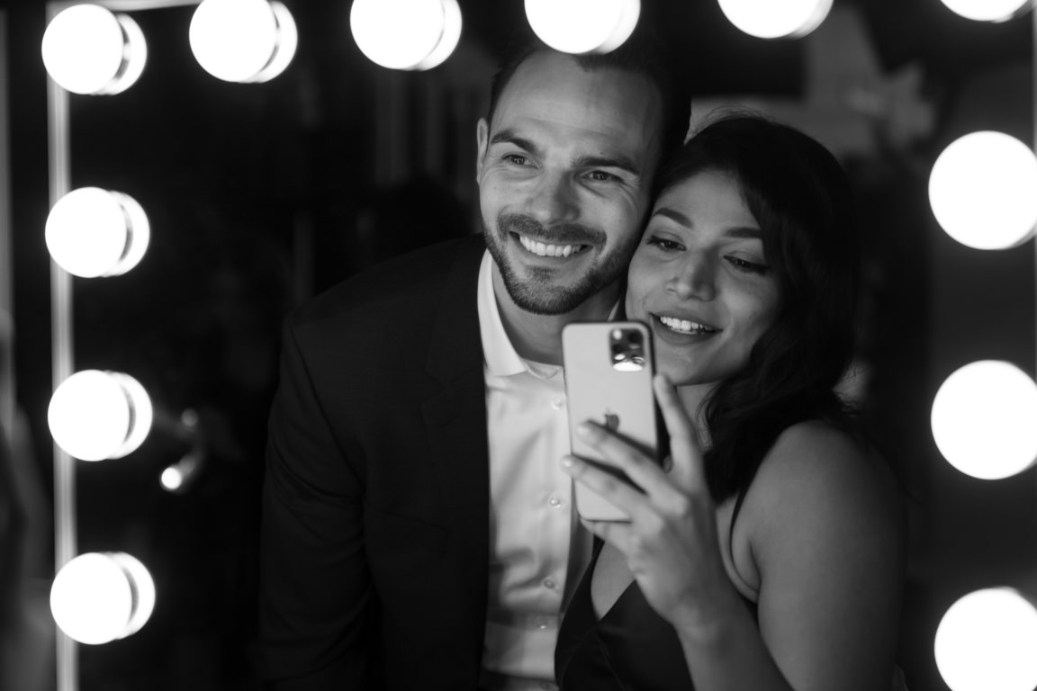 couple taking selfie in mirrors